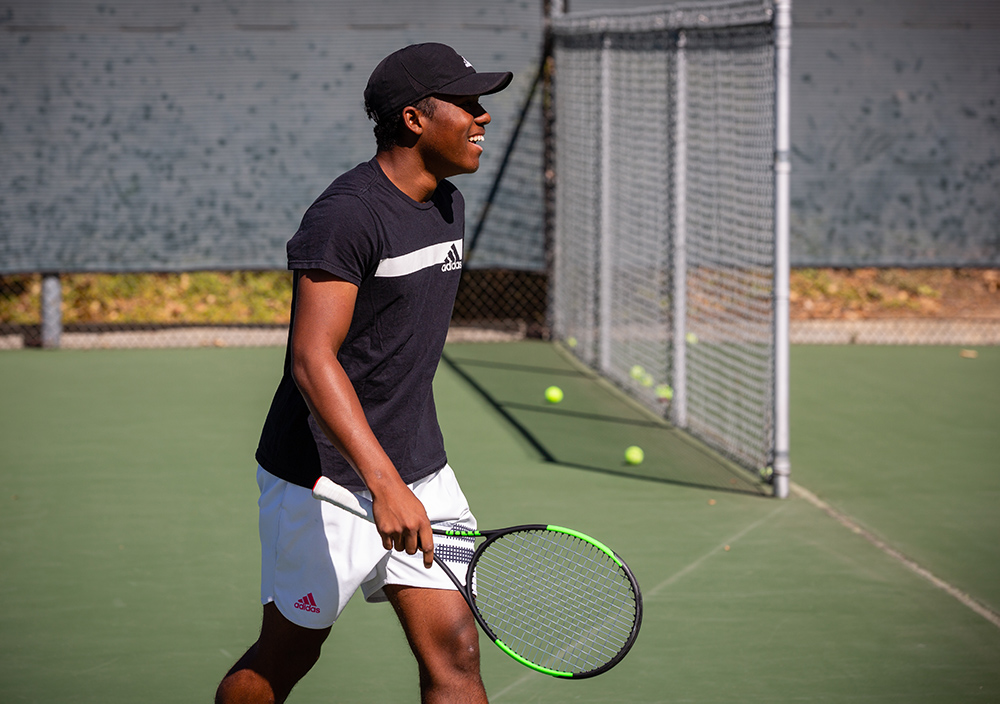 J.B. Badon relaxing on the tennis court